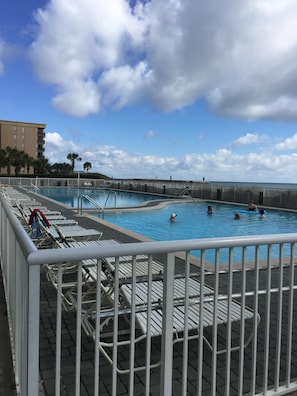 Guests can enjoy a refreshing swim in the pool surrounded by lounge chairs and umbrellas.
