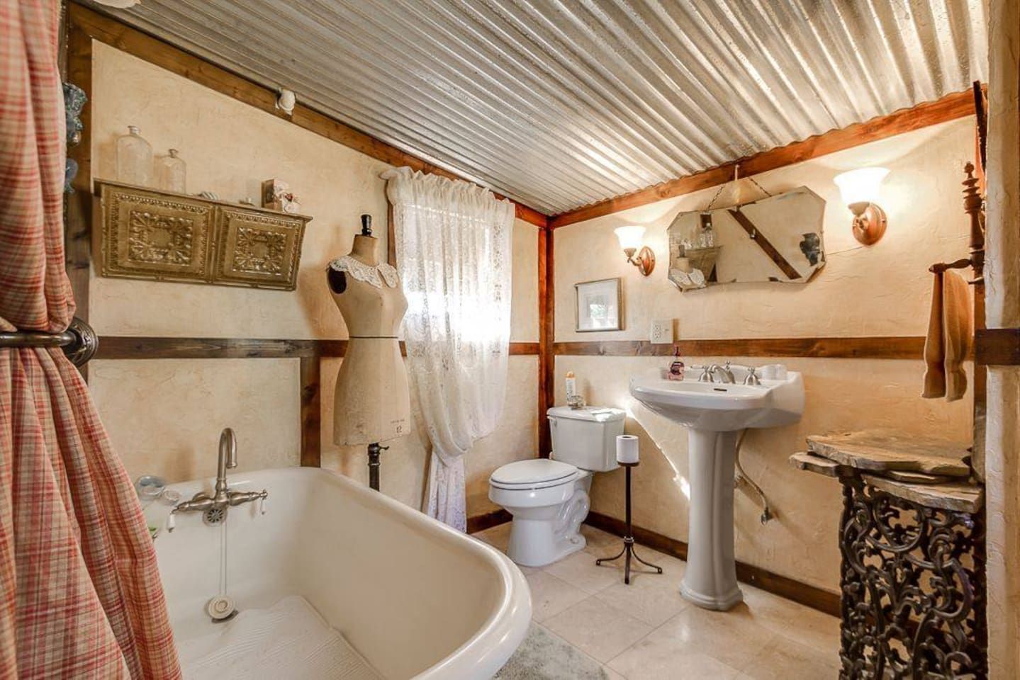 A bathroom with a bathtub, toilet, and sink.