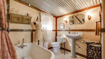 A bathroom with a bathtub, toilet, and sink.