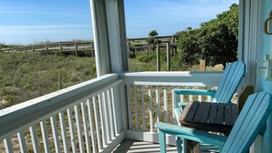 A covered porch with a view of the beach and dunes. - Oceanfront 2BR/2Bath Condo in Carolina Beach NC  (Carolina Beach)