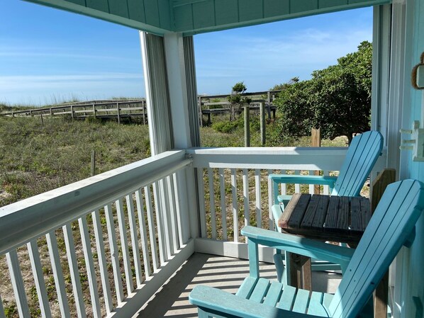 A covered porch with a view of the beach and dunes. - Oceanfront 2BR/2Bath Condo in Carolina Beach NC (Carolina Beach)