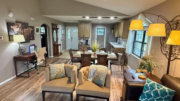 A spacious living room with a dining area, a kitchen, and a view of the outside. - Top-Floor Branson Condo w/ Stunning Views & 2 King Beds (Branson)