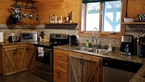 Upgraded kitchen! New cupboard doors, counter top and back splash.