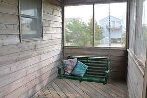 Relax on the porch with a view of the surrounding neighborhood.