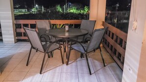 A covered outdoor patio with a round table and six chairs. - Home away from home ... secure and serene location with all the comforts of home (Christiansted)