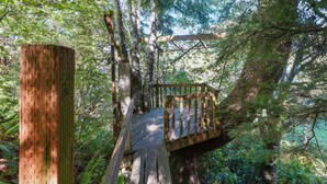 A wooden bridge in a forest. - Family Favorite! Treehouse,Huge Yard,Firepit & EV Charger.Walk to town & beach (Nehalem)