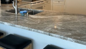 A kitchen with white cabinets, a stainless steel sink, a microwave, and a refrigerator. - ~ Music by the Sea ~ On the Beach ~ Hear the Ocean Surf~ (Indian Rocks Beach)