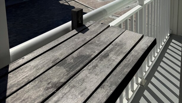 A wooden deck with a railing overlooking a beach. - ~ Music by the Sea ~ On the Beach ~ Hear the Ocean Surf~ (Indian Rocks Beach)