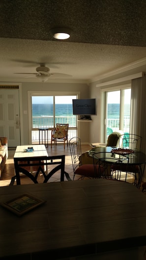 Enjoy ocean views from the large window in this room, which features a flat-screen TV, ceiling fan, and comfortable seating area.