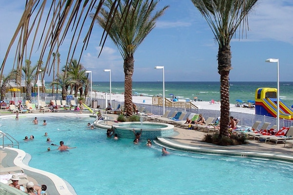 Large heated pool with a lot of seating and a cocktail bar right next to it