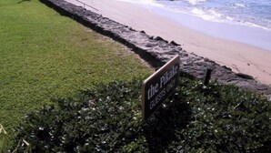 A coastal view with a sign indicating 'The Pikahe Guests Only'. - Pikake - West Maui Beachfront Condo! 20 Feet from the Ocean! (Lahaina)