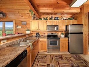 Enjoy cooking in this well-equipped kitchen with a dishwasher, double oven, microwave, and refrigerator.