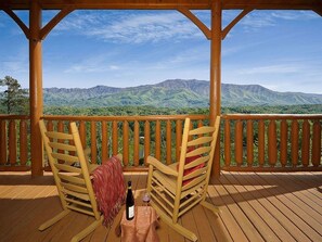 Relax on the deck with a glass of wine, taking in the breathtaking views of the surrounding mountains.