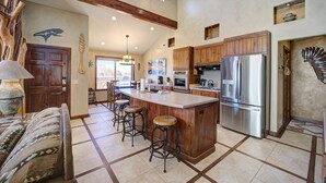 A spacious kitchen with a large island, wooden cabinets, and stainless steel appliances. - High End Southwest Luxury, Spa-like Baths, Steam Shr, Sauna, Garage,Pool,Hot Tub (Moab)