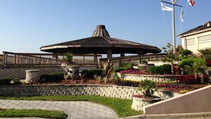 A gazebo with a "Welcome to Kitty Coast" sign, surrounded by landscaped gardens and a stone wall. - HIDDEN GEM 1BR/1BA BEACH PROPERTY AT JETTY EAST, DESTIN , FLORIDA  (Destin)