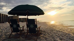 Two beach chairs with a green umbrella, a sandy beach, and a sunset in the background. - HIDDEN GEM 1BR/1BA BEACH PROPERTY AT JETTY EAST, DESTIN , FLORIDA  (Destin)
