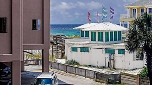 A coastal building with a white roof and multiple flags, overlooking the ocean. - HIDDEN GEM 1BR/1BA BEACH PROPERTY AT JETTY EAST, DESTIN , FLORIDA  (Destin)