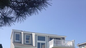 A two-story house with a swimming pool in the front yard.
