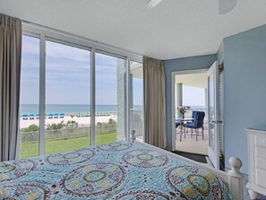 Enjoy stunning ocean views from the comfort of your room, featuring a large bed and balcony with seating area.