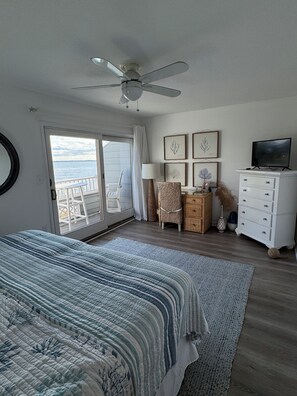 A bedroom with a bed, a television, a dresser, and a ceiling fan. - Waterfront Townhouse! Gorgeous Sunsets! 2 Decks on Water! (Ocean City)