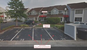 A parking lot with assigned spots and a guest parking area. - Waterfront Townhouse!  Gorgeous Sunsets!  2 Decks on Water! (Ocean City)