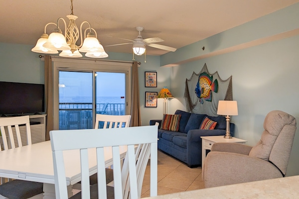 The living room, dining area, and kitchen all have Gulf views.