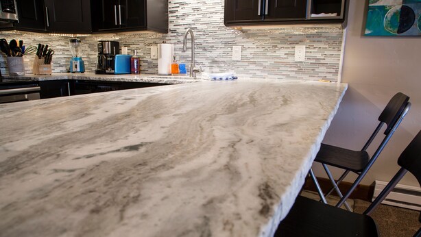 A kitchen with a marble countertop, a sink, and a coffee maker. - 500 Ft. From Slope! Remodeled Studio  (Steamboat Springs)