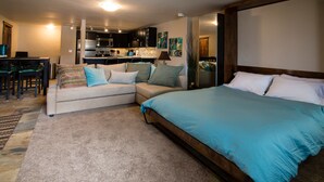 A modern living room with a sofa, a bed, and a dining area. - 500 Ft. From Slope! Remodeled Studio  (Steamboat Springs)