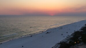 A beach with a sunset in the background.