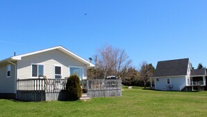 A single-story house with a fenced yard and a small tree in front. - 2 bedroom, A/C, Sleeps 6 (New London)