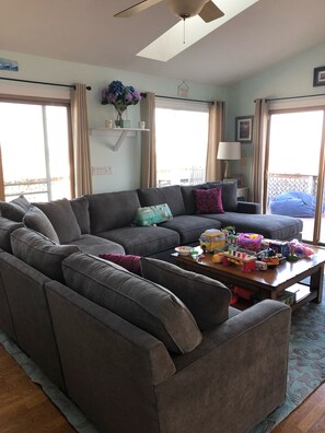 Relax in this inviting living room with a sofa, coffee table, and toys for the kids.