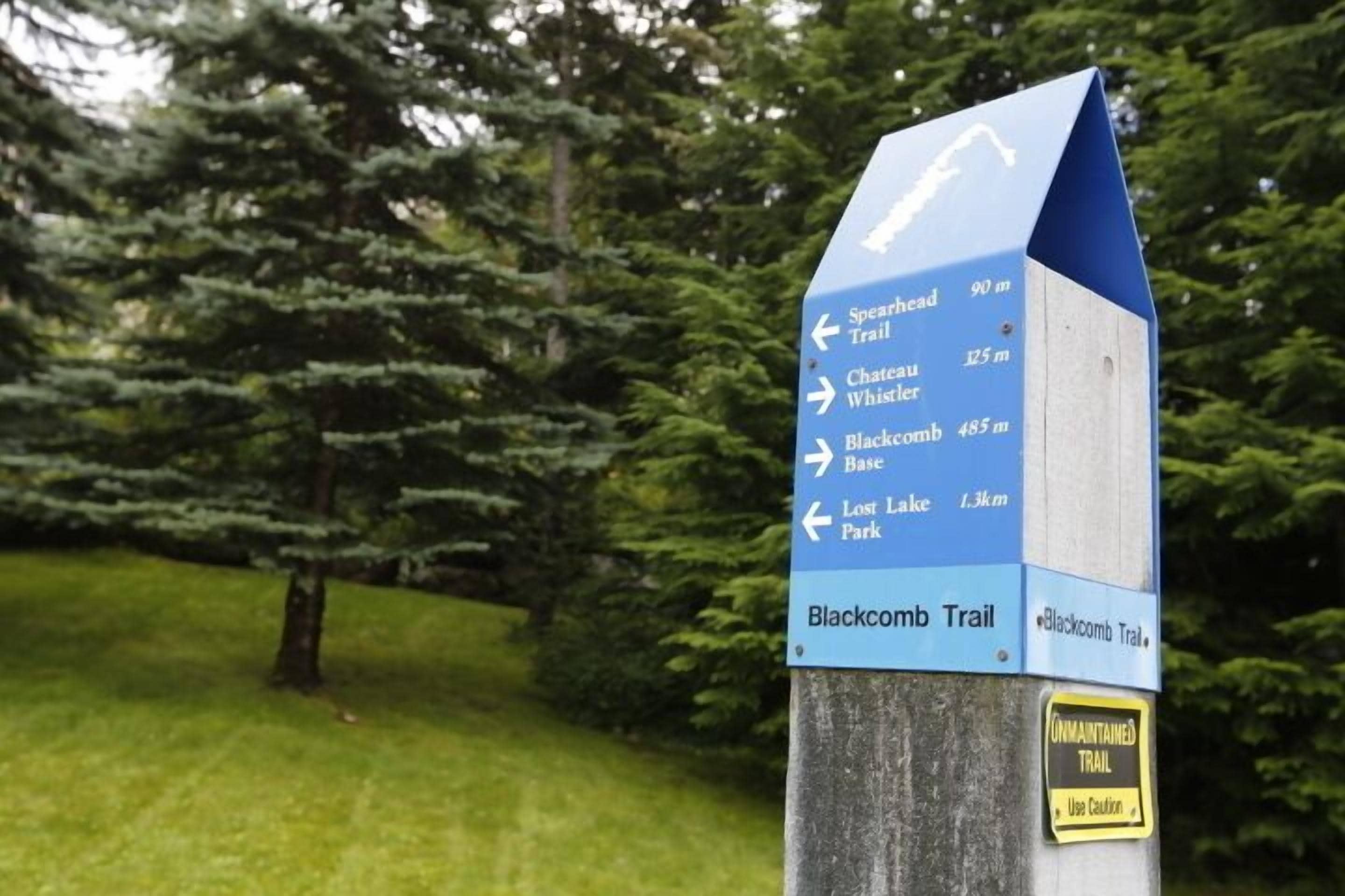 A directional signpost with multiple trail directions and distances.