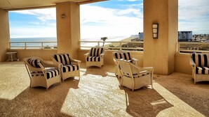 A balcony with wicker furniture and a view of the ocean. - GREAT GALVESTON GETAWAY! STRESS-FREE BEACH VACATION! (Galveston)