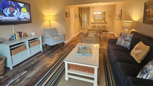 A living room with a television, a ceiling fan, a sofa, a coffee table, and a chair. - Updated 2 BR/ 2.5 Bath Close to everything you need. (Hilton Head Island)