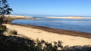 A beach with clear skies and calm waters.