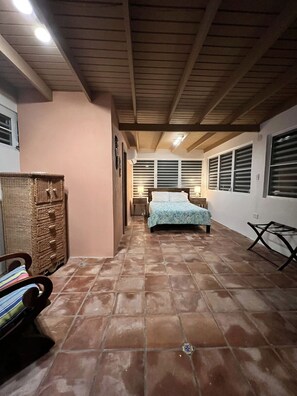 Cozy retreat with a bed, bedside lamps, and a dresser.