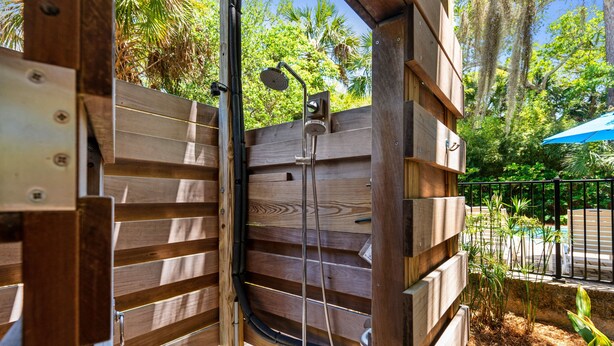 A wooden pergola structure with a built-in shower system. - Private Oasis with a Large Saltwater Pool Close to Everything - Screened Porch and Deck Open Concept (Folly Beach)