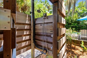 A wooden pergola structure with a built-in shower system. - Private Oasis with a Large Saltwater Pool Close to Everything - Screened Porch and Deck Open Concept (Folly Beach)