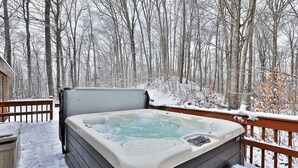 A hot tub on a wooden deck surrounded by a snowy forest. - Killington Cabin: Right Unit - Sleeps 10 in 4 BR, 2 BA Cozy Escape (Killington)