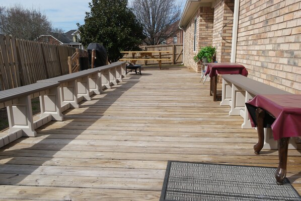 Enjoy outdoor dining and relaxation on this deck with a picnic table and comfortable seating areas.