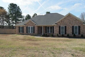 Stroll up to this charming home with a welcoming front porch and beautifully manicured lawn.
