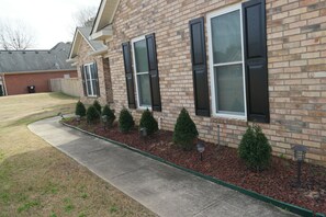 Stunning residential building with a beautifully maintained front yard and gravel pathway.
