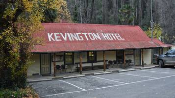 A building with a red roof labeled 'KEVINGTON HOTEL.'