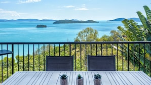 A balcony with a view of a calm sea and distant islands. - Panorama 15, Seaview Apartment on Hamilton Island (Hamilton Island)
