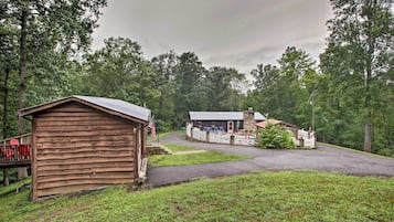 Escape to a serene forest retreat with a rustic lodge featuring a wooden structure and a charming stone building.