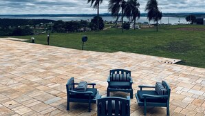 A patio with outdoor furniture and a view of a grassy area and trees. - Dream, Dam, heated pool, 4 suites. Coffee shop, Restaurant, Burger joint.<br><br> <br><br><br><br><br><br><br><br><br> (Paranapanema)