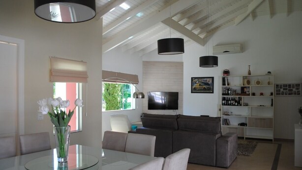A modern living room with a glass dining table, a gray sofa, and a TV mounted on the wall. - Dream, Dam, heated pool, 4 suites. Coffee shop, Restaurant, Burger joint.<br><br> <br><br><br><br><br><br><br><br><br> (Paranapanema)