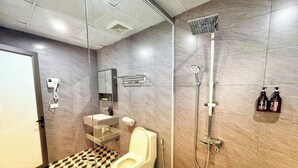 A modern bathroom with a toilet, sink, mirror, shower, and tiled floor. -  Belle Maison Sapa Resort & Spa - Formerly Sapa Eco Villas & Spa (Ta Van)