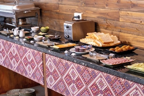 A buffet counter with various food items and a coffee machine. - Belle Maison Sapa Resort & Spa - Formerly Sapa Eco Villas & Spa (Ta Van)