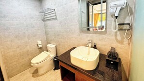 A bathroom with a toilet, sink, mirror, towel rack, and hairdryer. -  Belle Maison Sapa Resort & Spa - Formerly Sapa Eco Villas & Spa (Ta Van)